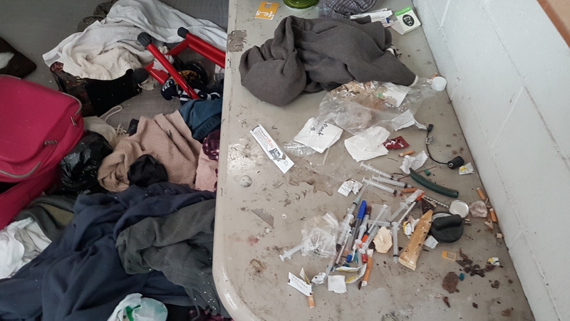 Drug paraphernalia and meth syringes in the floor